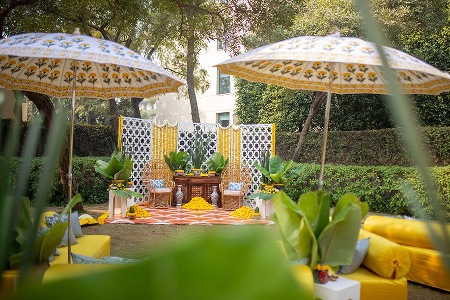 Yellow seating and patterned parasols for a haldi