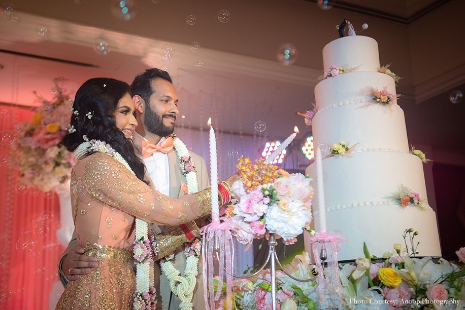 A couple cutting their celebration cake